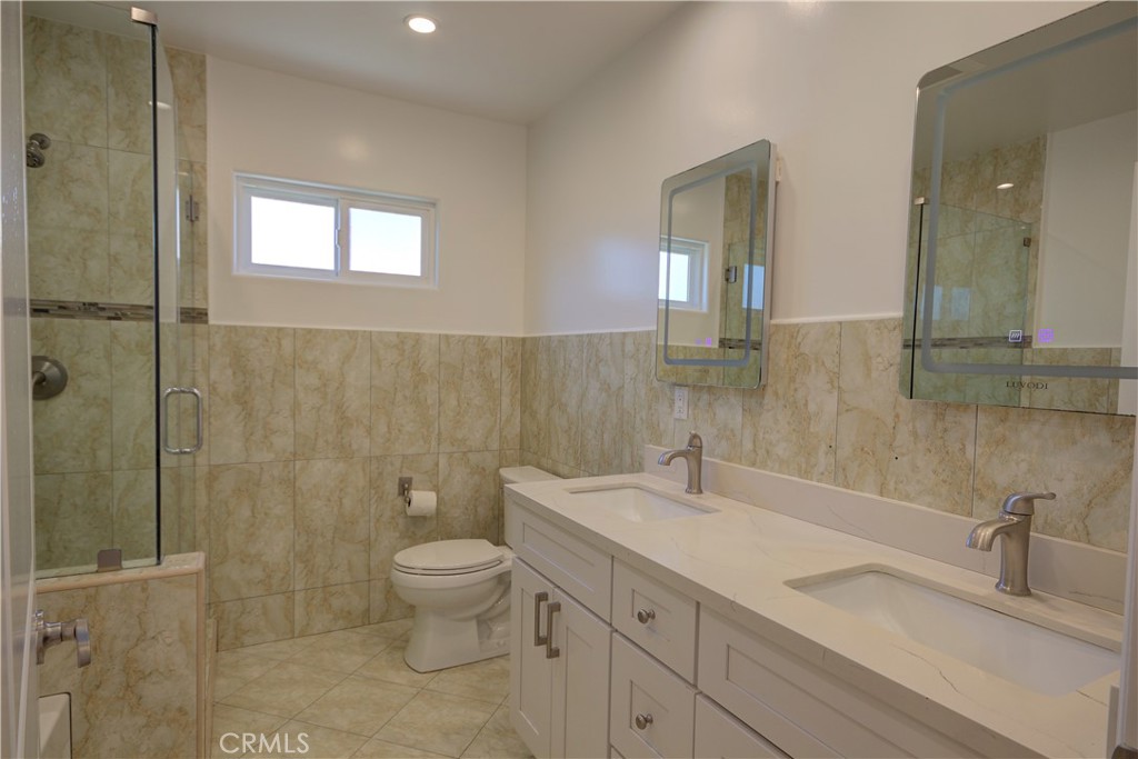1367 East Windsor Road Glendale, CA 91205 - Photo 10 of 21 a bathroom with a double vanity sink toilet and shower