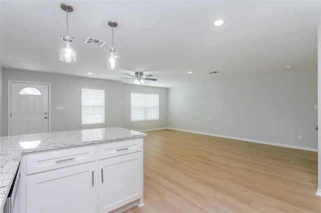 a view of a kitchen counter space and wooden floor