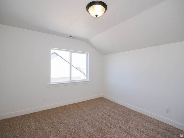 3938 North Wood Road Eagle Mountain, UT 84005 - Photo 39 of 55 Additional living space with vaulted ceiling and carpet floors