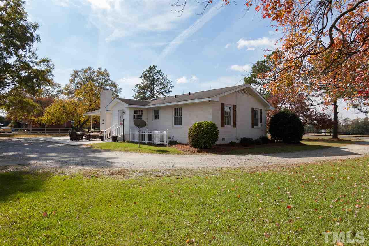 9409 Sauls Road Raleigh, NC 27603 - Photo 22 of 25 a view of a house with a yard and garage
