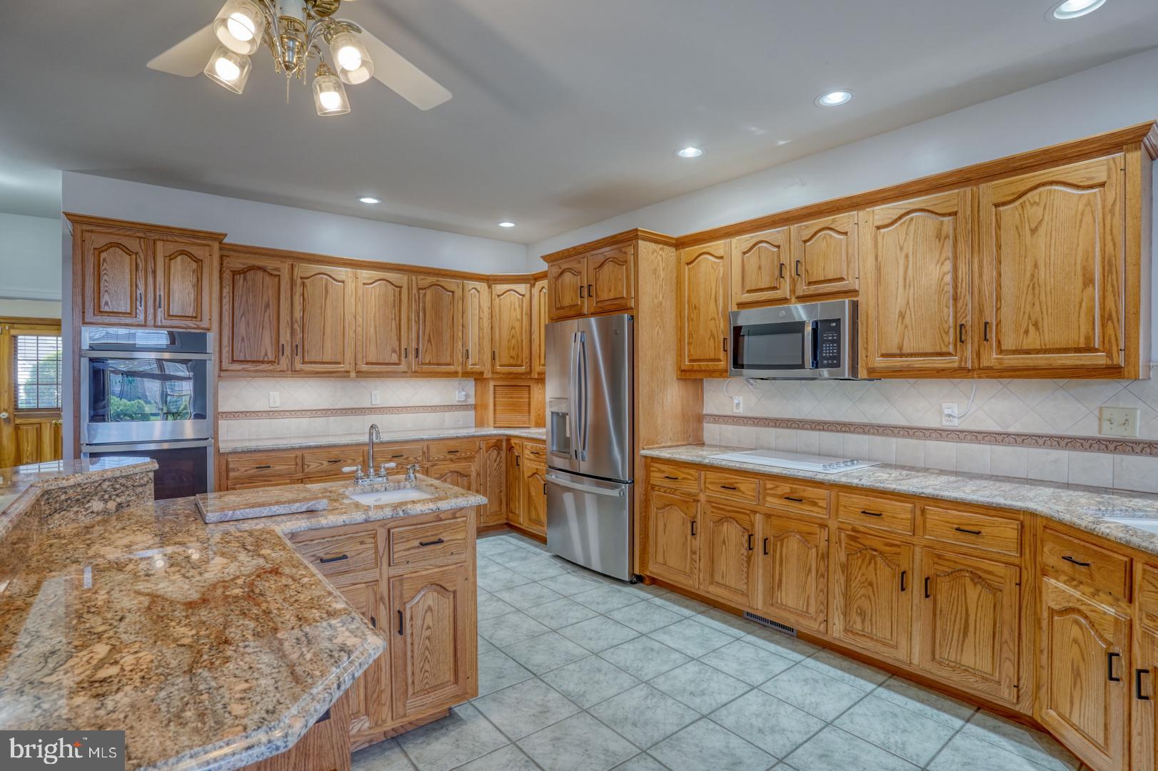 34 Chadwick Drive Dover, DE 19901 - Photo 32 of 59 a kitchen with stainless steel appliances granite countertop a refrigerator sink and cabinets
