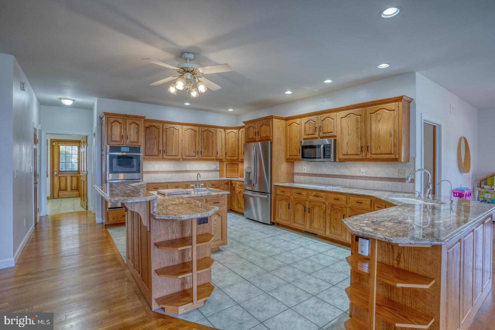 34 Chadwick Drive Dover, DE 19901 - Photo 35 of 59 a kitchen with kitchen island granite countertop wooden cabinets and refrigerator
