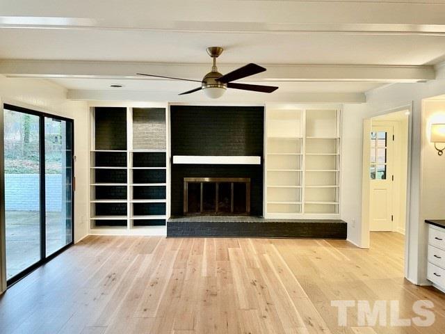 700 Lakestone Drive Raleigh, NC 27609 - Photo 7 of 35 a view of an empty room with a window and wooden floor