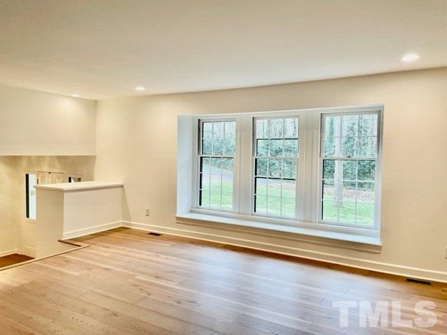 700 Lakestone Drive Raleigh, NC 27609 - Photo 8 of 35 a view of empty room with wooden floor and fan