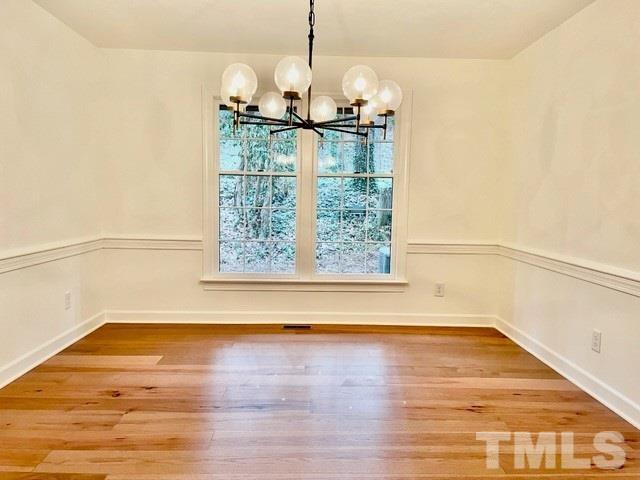 700 Lakestone Drive Raleigh, NC 27609 - Photo 9 of 35 a view of empty room with wooden floor and fan