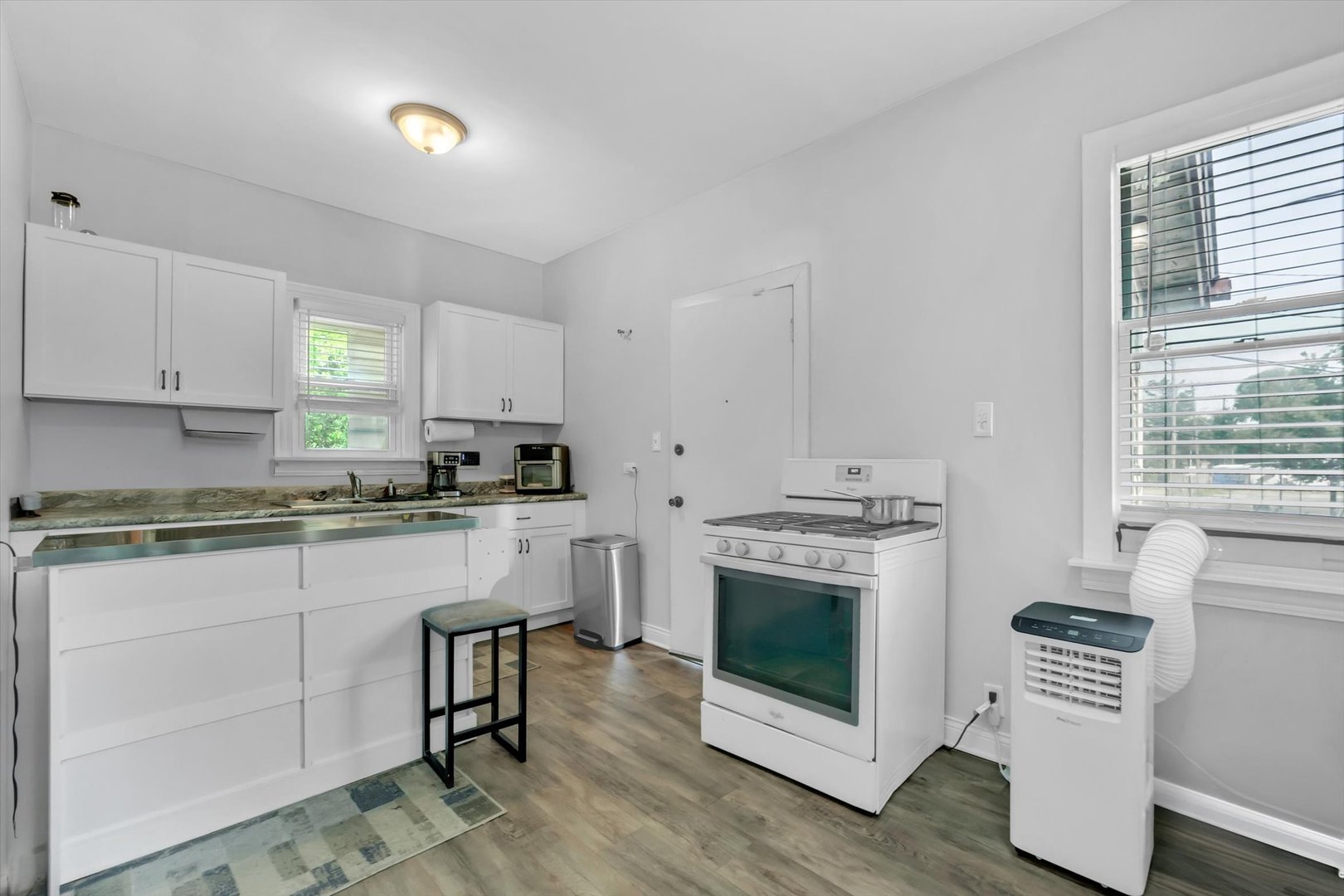 10004 South Torrence Avenue Chicago, IL 60617 - Photo 2 of 46 a kitchen with granite countertop white cabinets and white appliances