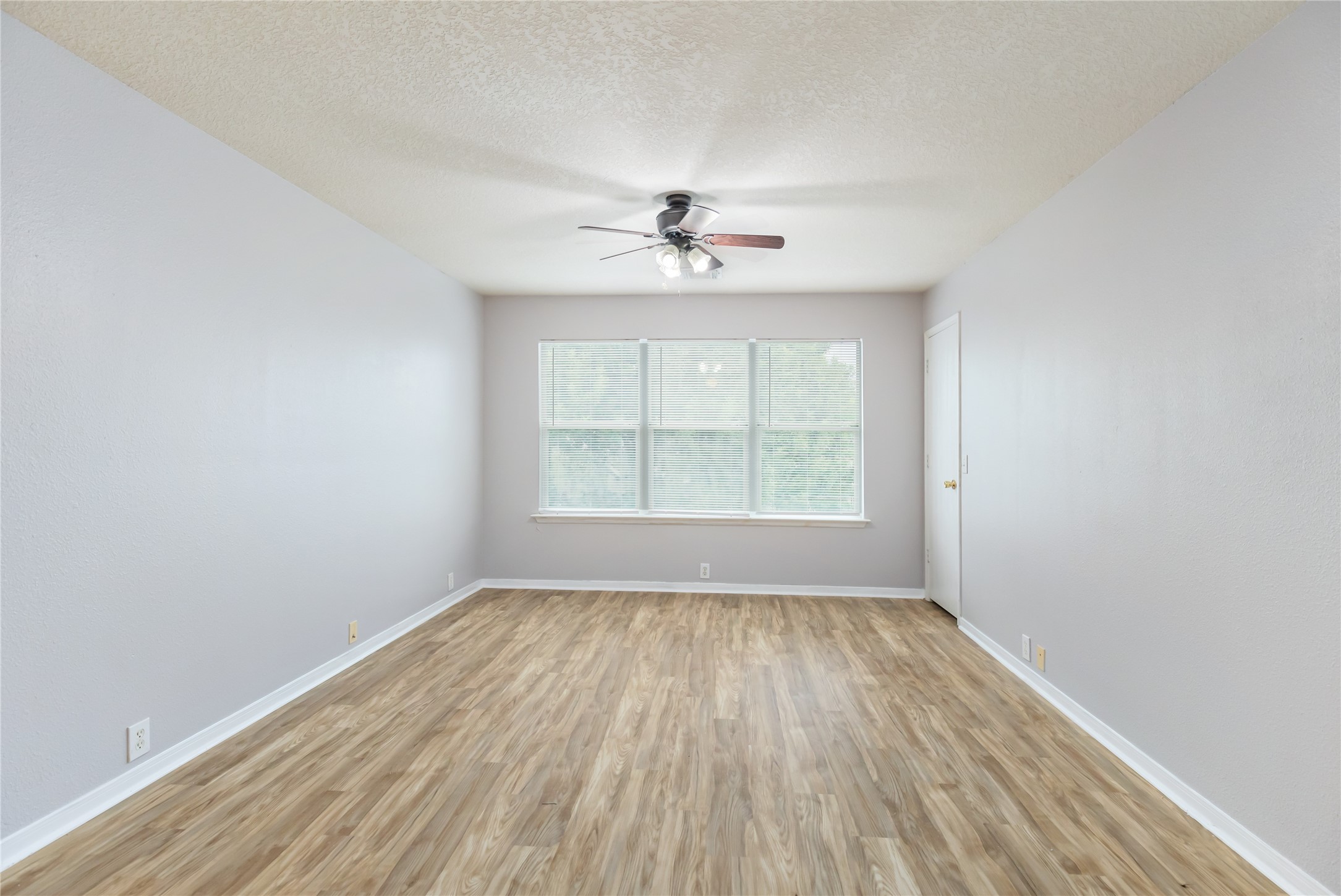 17334 Turquoise Stream Drive Houston, TX 77095 - Photo 18 of 31 an empty room with a window and a ceiling fan