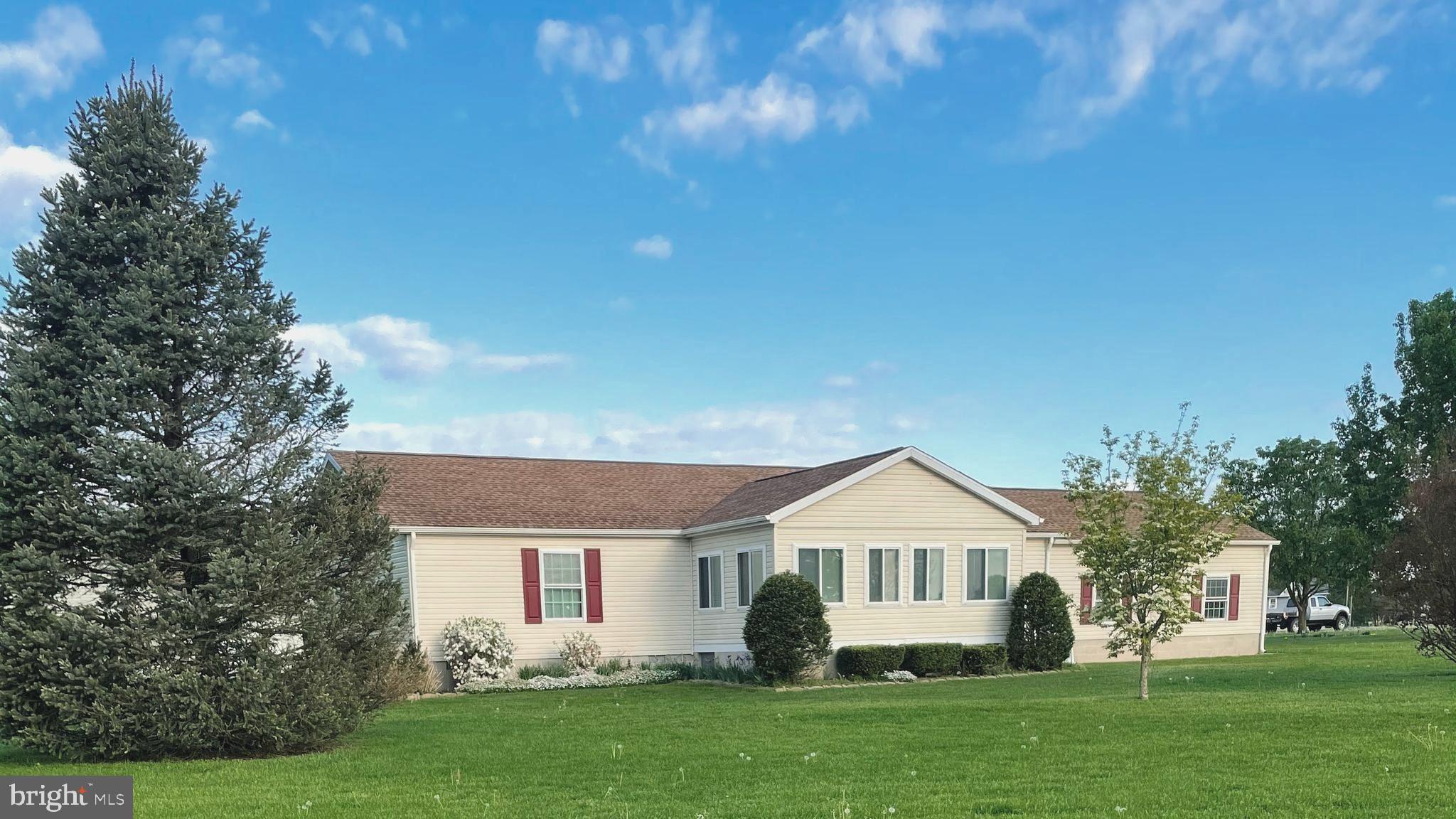 Charming home with lush green surroundings.