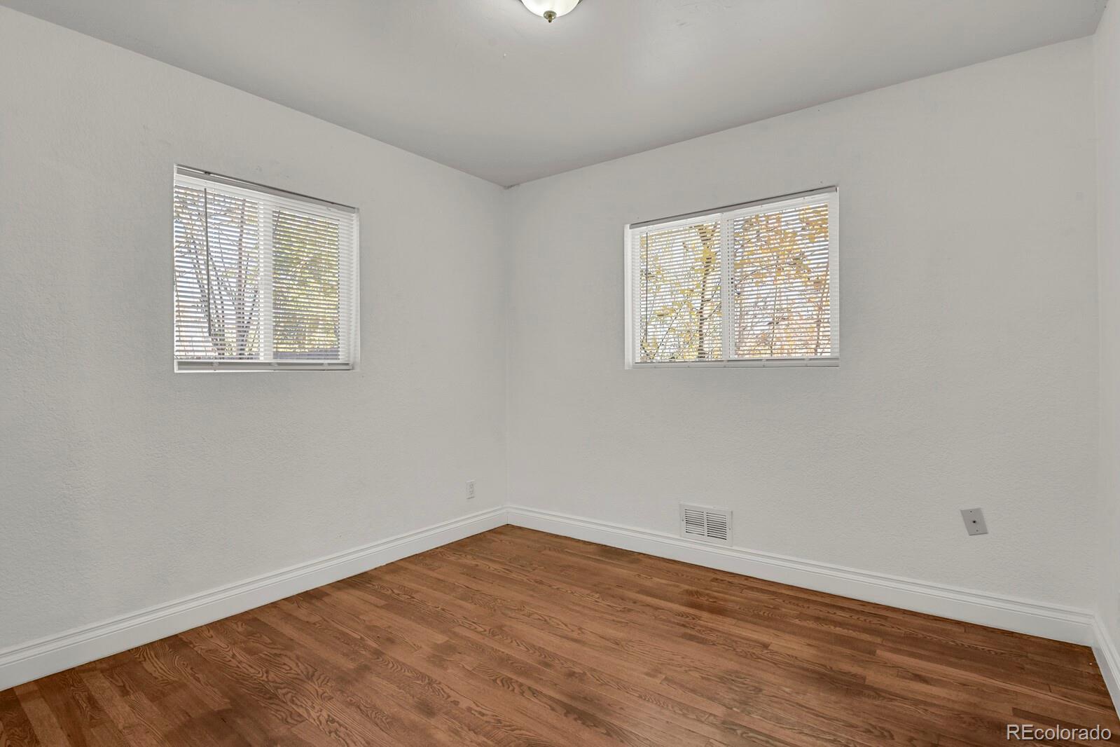 3720 Miller Street Wheat Ridge, CO 80033 - Photo 11 of 17 a view of room with wooden floor and window