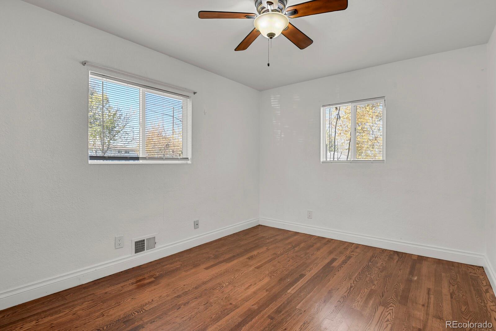 3720 Miller Street Wheat Ridge, CO 80033 - Photo 9 of 17 a view of an empty room with wooden floor and a window