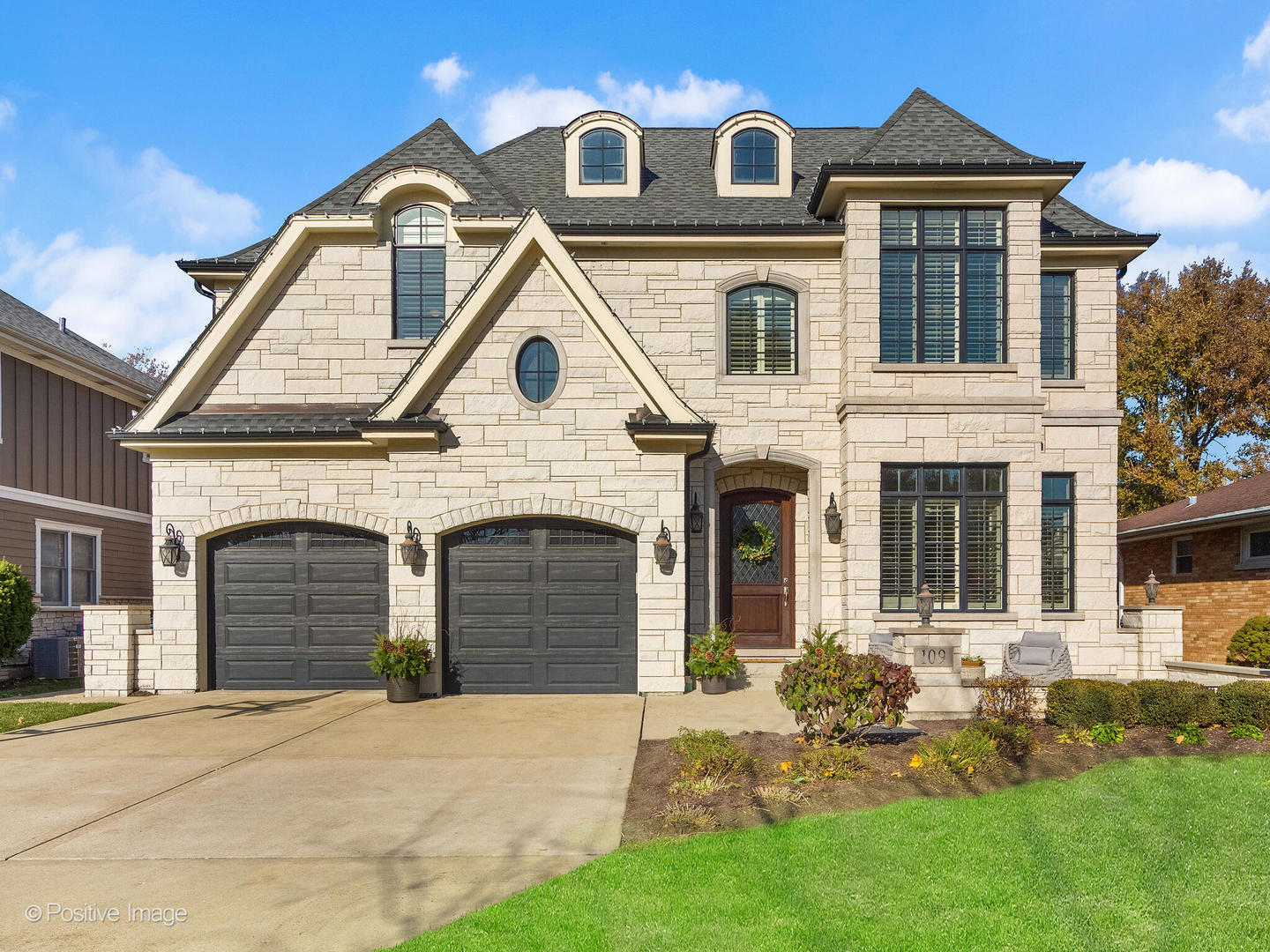 a front view of a house with a yard and garage