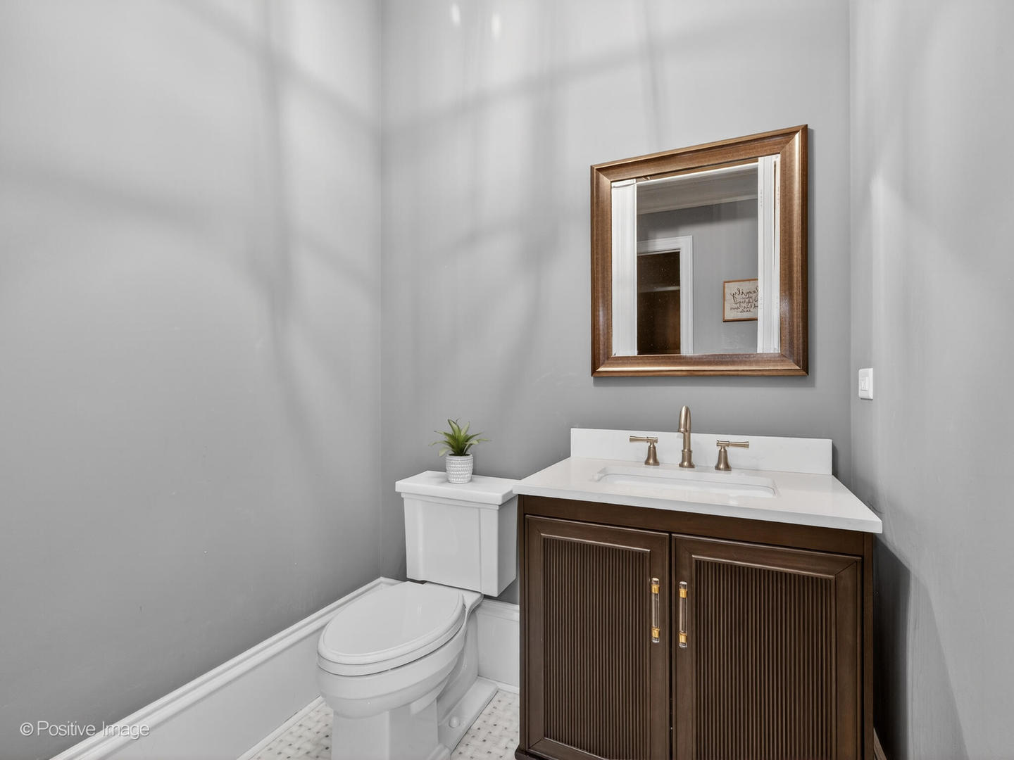 109 East Madison Street Elmhurst, IL 60126 - Photo 23 of 56 a bathroom with a toilet a sink and mirror