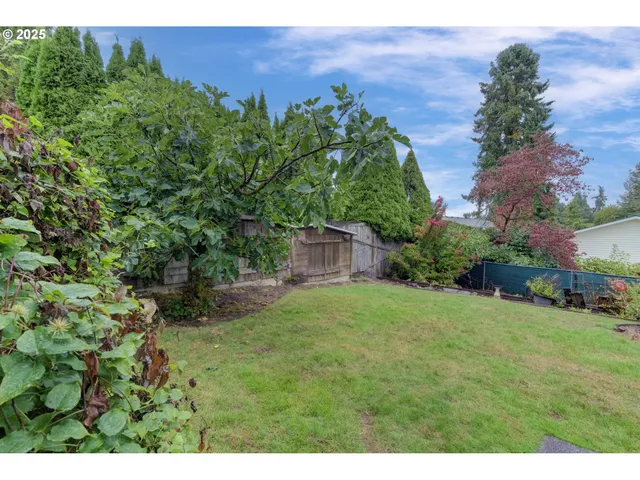 a view of a lake with a yard and potted plants