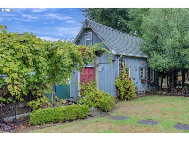a backyard of a house with table and chairs