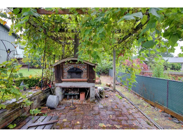 a view of a backyard with wooden fence