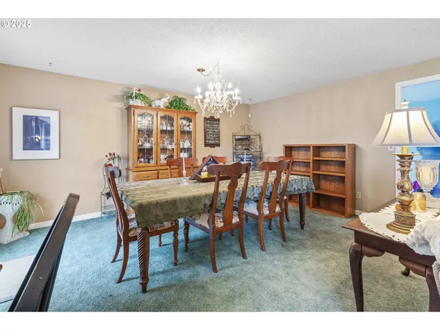 a view of a dining room with furniture and chandelier