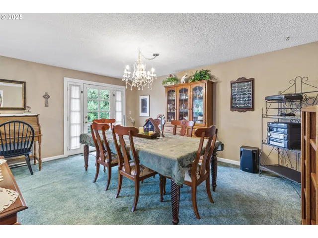 a living room with lots of furniture chandelier and a dining table