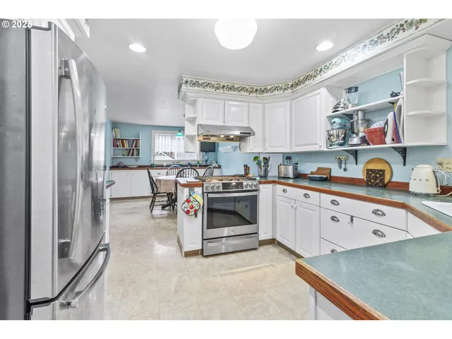 a kitchen with a sink stove and refrigerator