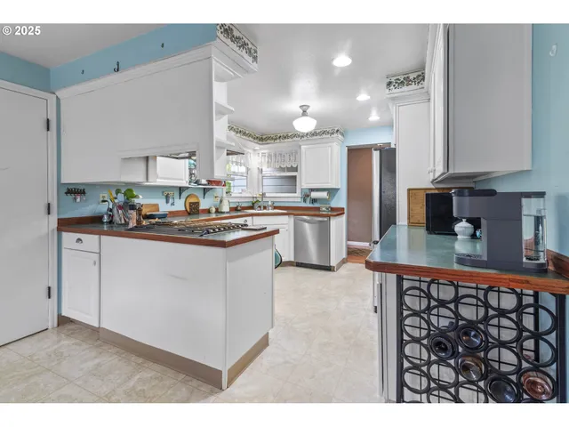 a view of a dining room with furniture and a chandelier