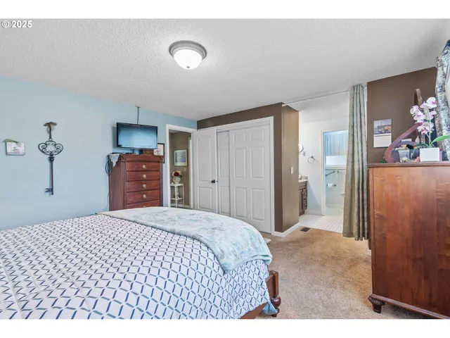 a bathroom with a granite countertop sink a mirror and a shower