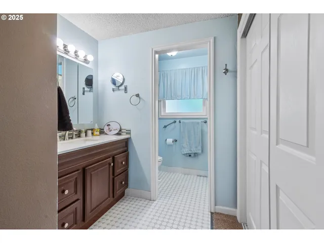 a spacious bedroom with a bed and a window