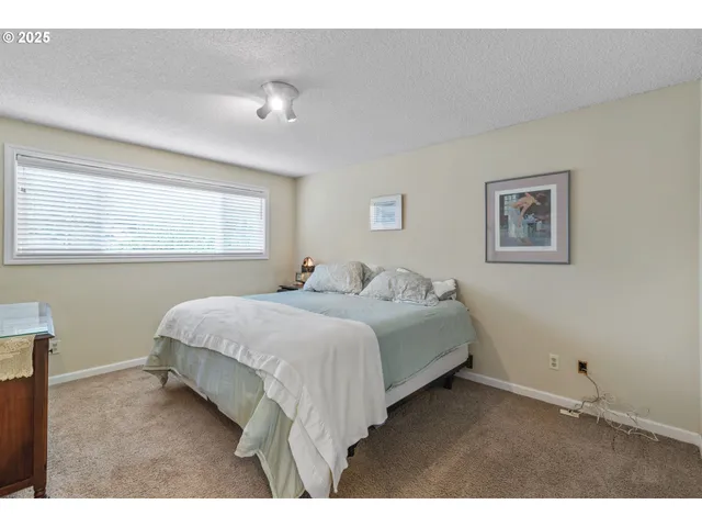 a bedroom with a bed and a table