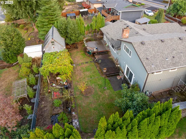 an aerial view of a house with a yard and garden