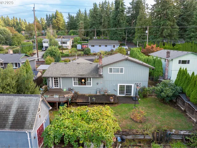 an aerial view of a house with swimming pool table and chairs