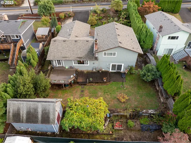 an aerial view of residential houses with outdoor space and swimming pool