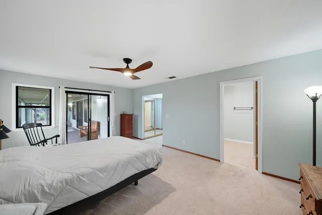 a bedroom with a large bed and a large window