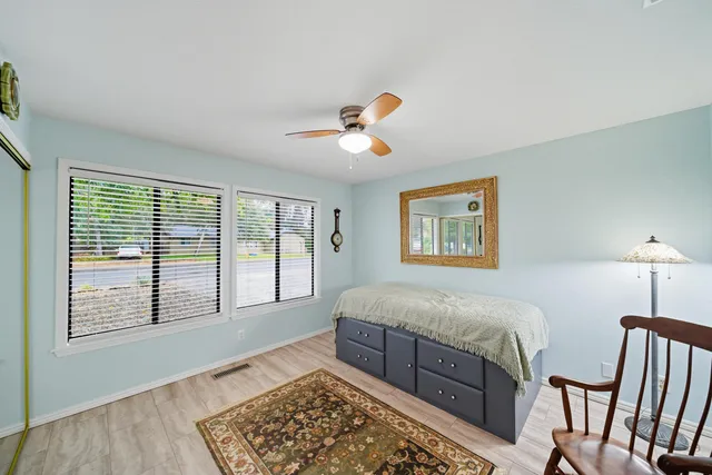 a bedroom with a bed and a chandelier