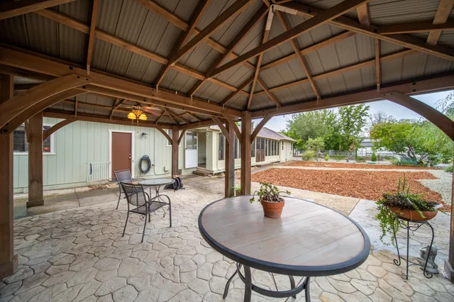 a view of a house with backyard and sitting area