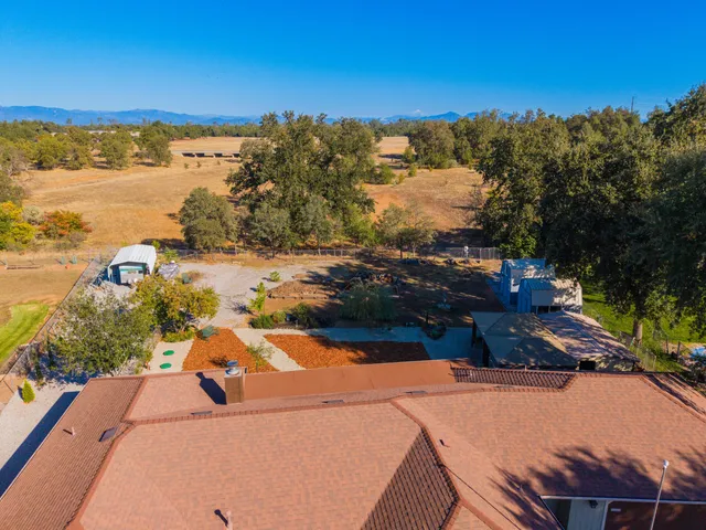 an aerial view of a house with a yard