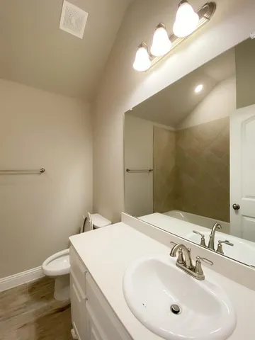 a kitchen with stainless steel appliances granite countertop a sink a stove top oven a counter space and cabinets