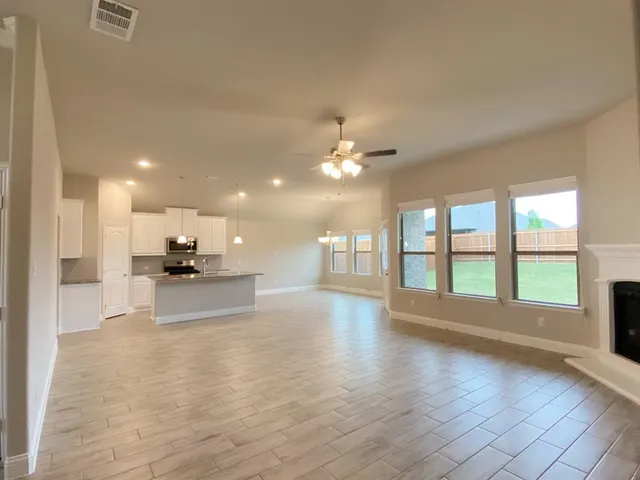 a view of a kitchen with a sink and a large window