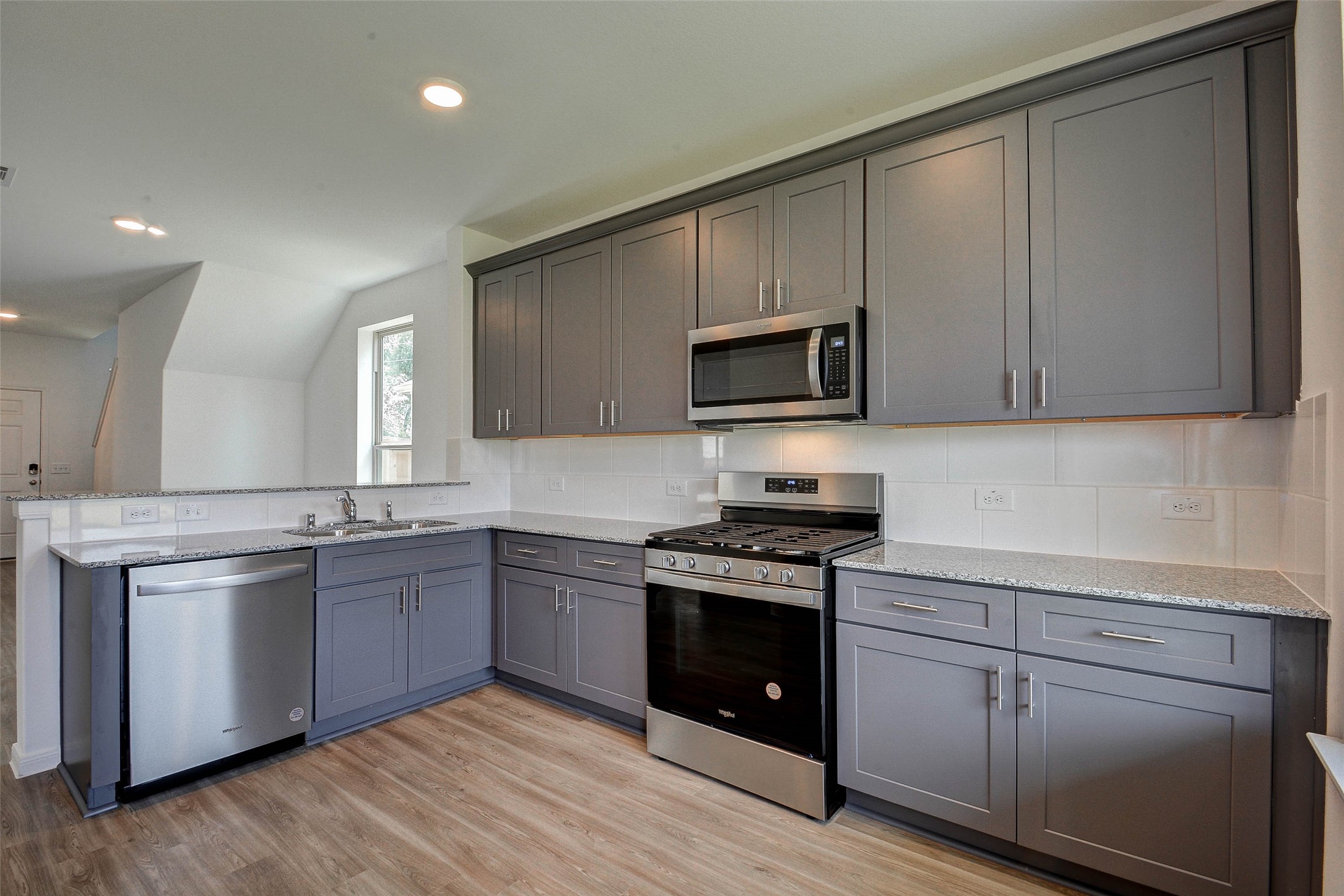 16642 Teak Mantle Road Conroe, TX 77302 - Photo 14 of 35 a kitchen with stainless steel appliances granite countertop wooden cabinets and a stove top oven