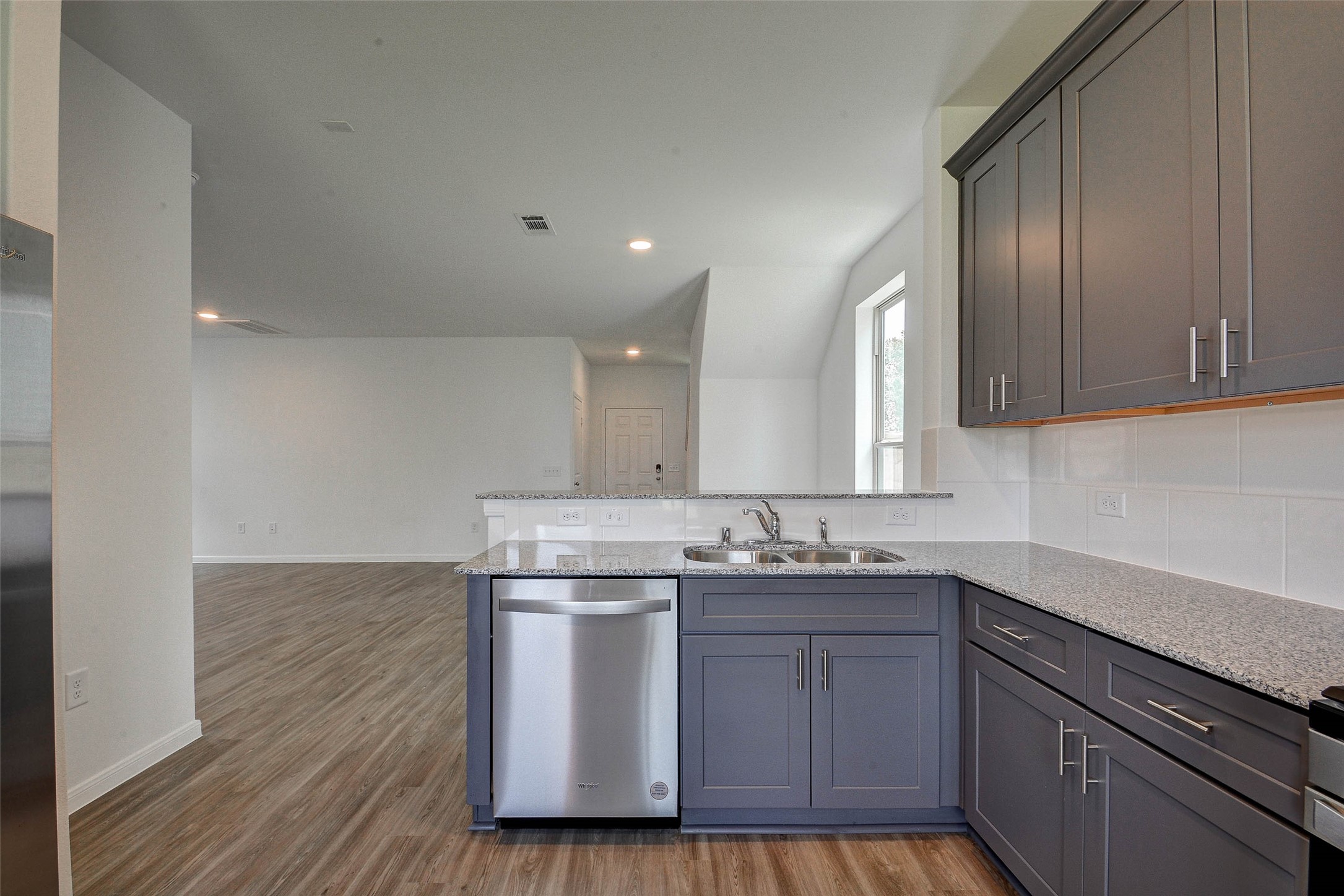 16642 Teak Mantle Road Conroe, TX 77302 - Photo 16 of 35 a kitchen with stainless steel appliances granite countertop a sink a stove a refrigerator and cabinets