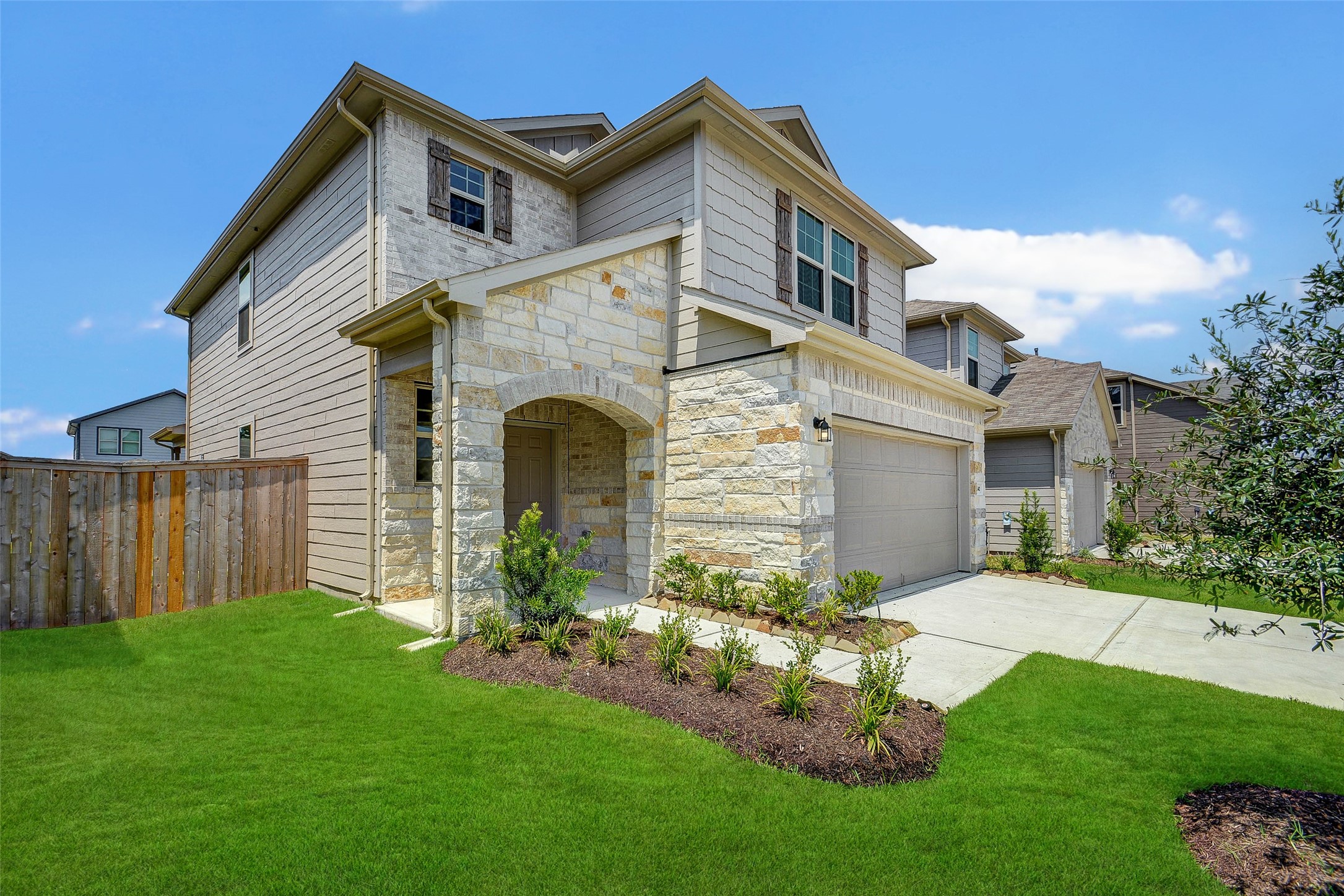 16642 Teak Mantle Road Conroe, TX 77302 - Photo 2 of 35 a front view of a house with a garden and yard