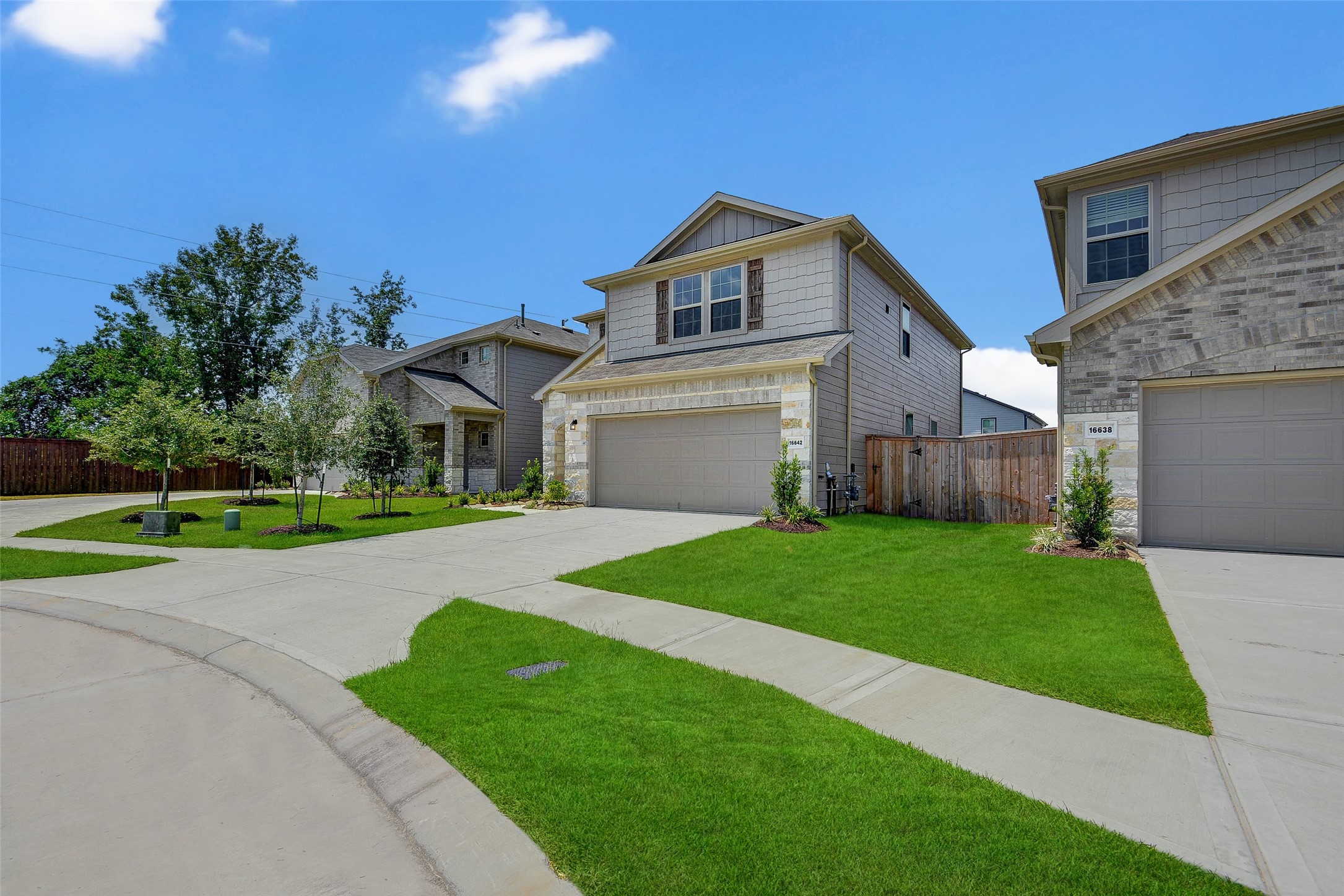 16642 Teak Mantle Road Conroe, TX 77302 - Photo 3 of 35 a front view of a house with a yard and garage