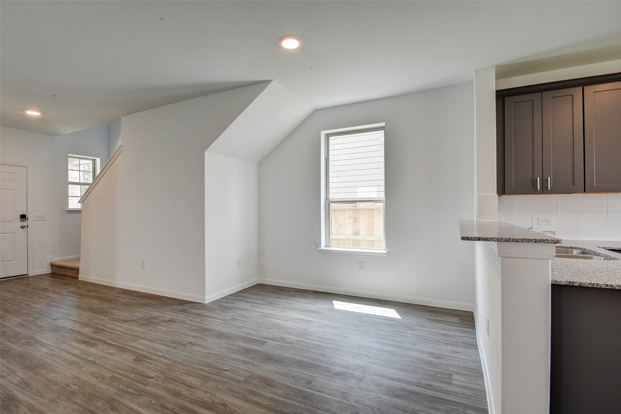 16642 Teak Mantle Road Conroe, TX 77302 - Photo 6 of 35 an empty room with wooden floor and windows