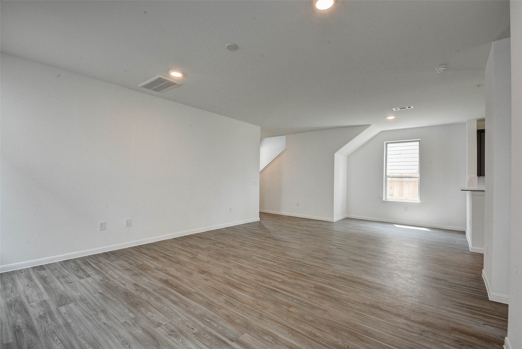 16642 Teak Mantle Road Conroe, TX 77302 - Photo 7 of 35 an empty room with wooden floor and windows