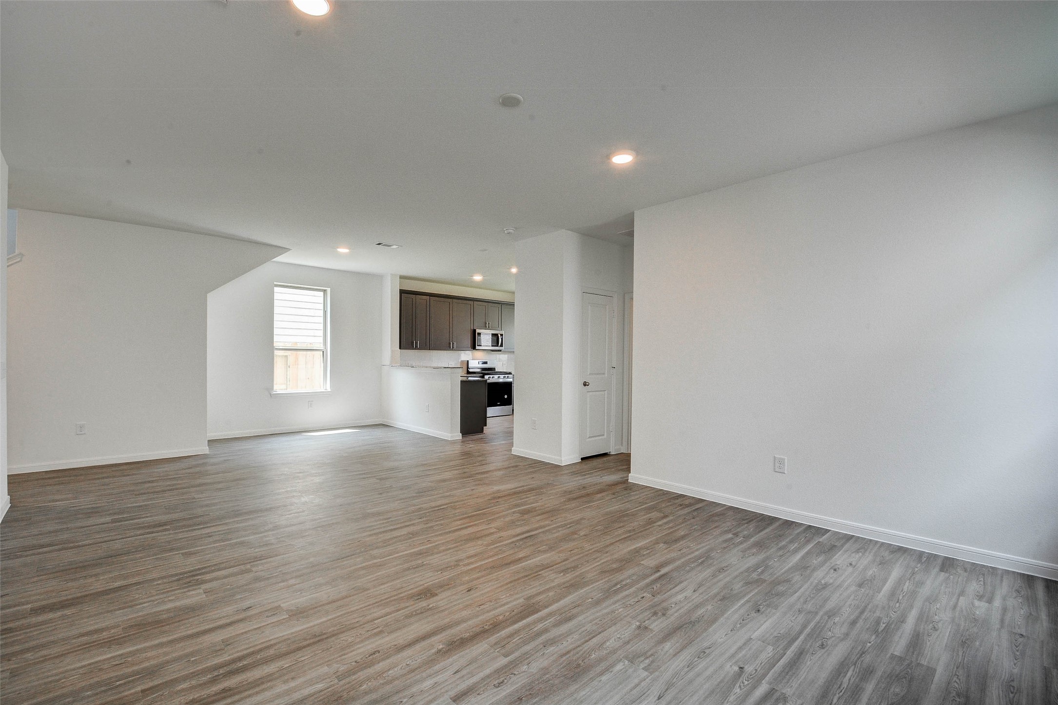 16642 Teak Mantle Road Conroe, TX 77302 - Photo 8 of 35 a view of empty room with kitchen and window