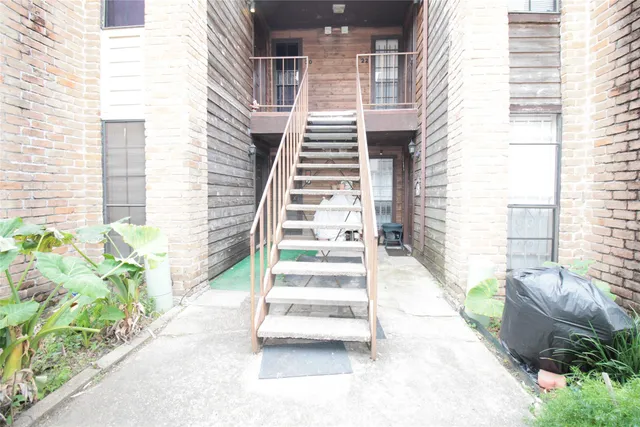 a view of a patio with table and chairs and potted plants