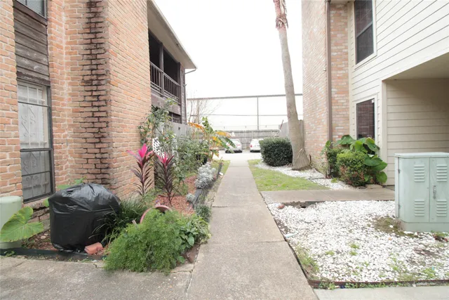 a view of a pathway that has potted plants