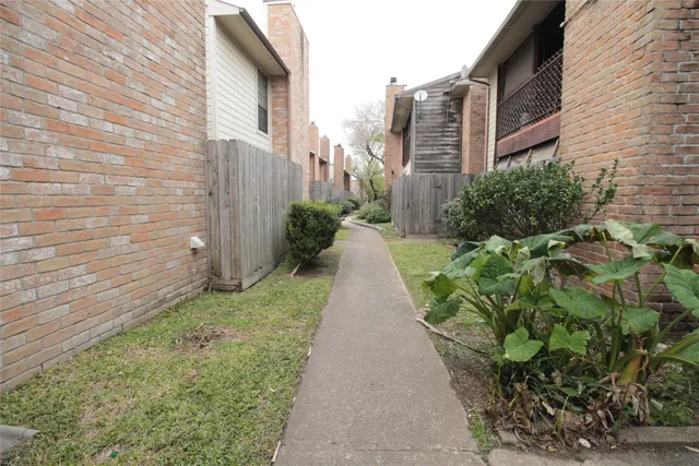 a view of a pathway both side of house