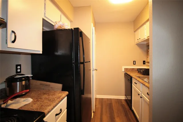 a kitchen with stainless steel appliances granite countertop a refrigerator and a stove