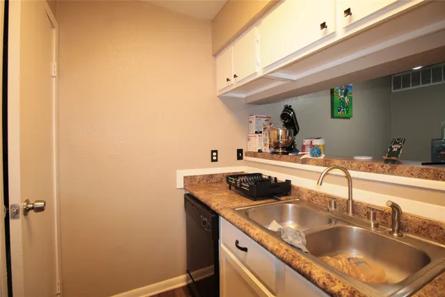 a kitchen with a sink and cabinets