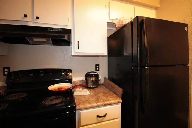 a kitchen with a sink a stove and refrigerator