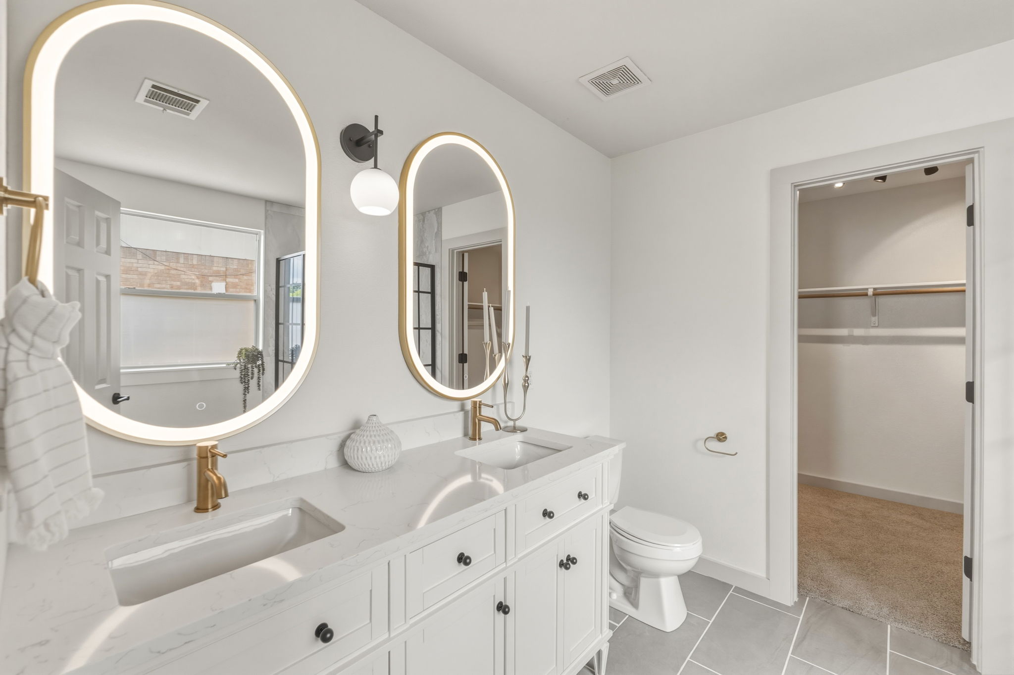 211 Banner Avenue Leander, TX 78641 - Photo 12 of 27 a bathroom with a sink a toilet and a mirror