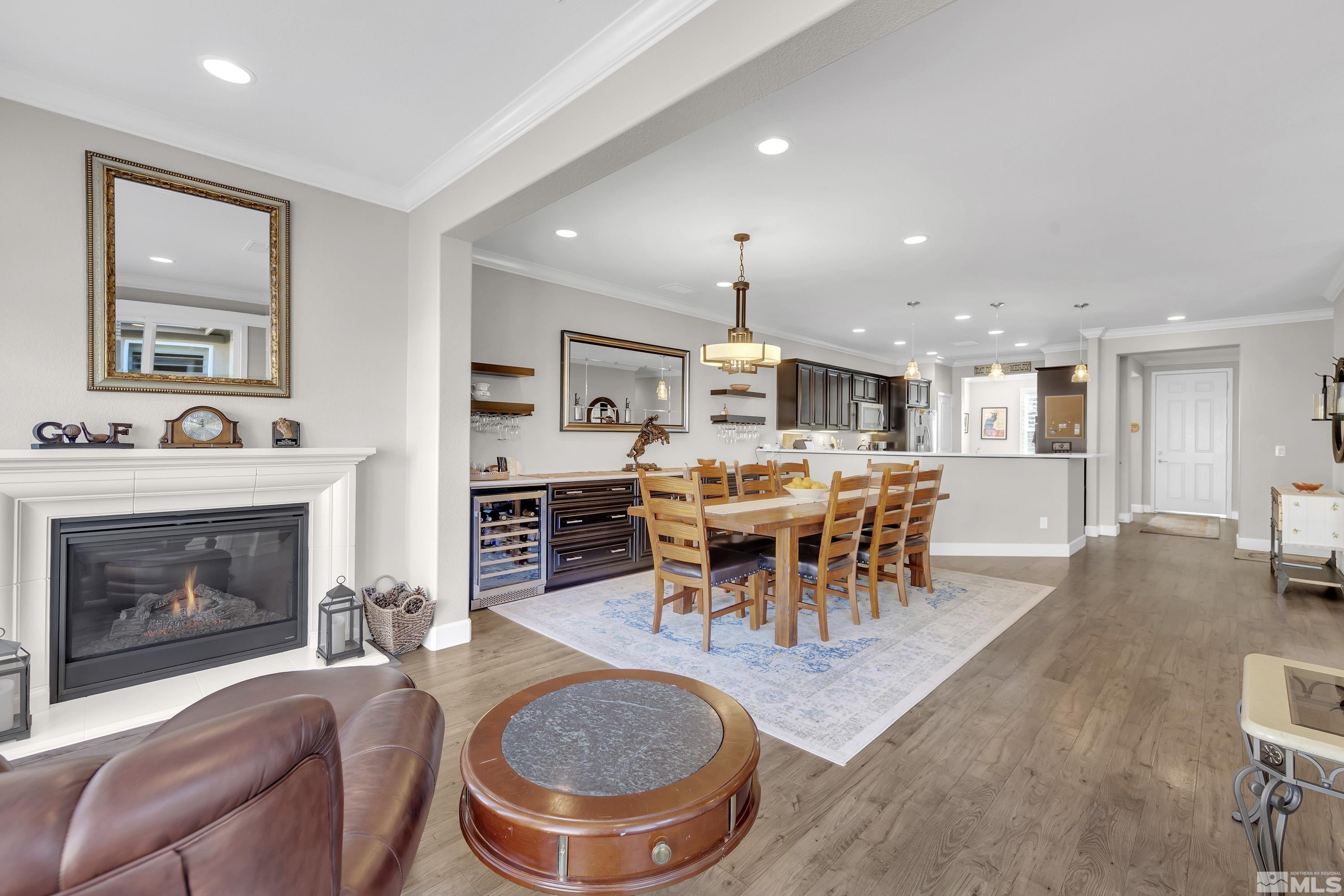 9255 Sassafras Trail Reno, NV 89523 - Photo 11 of 25 a dining room with furniture a fireplace and a kitchen view